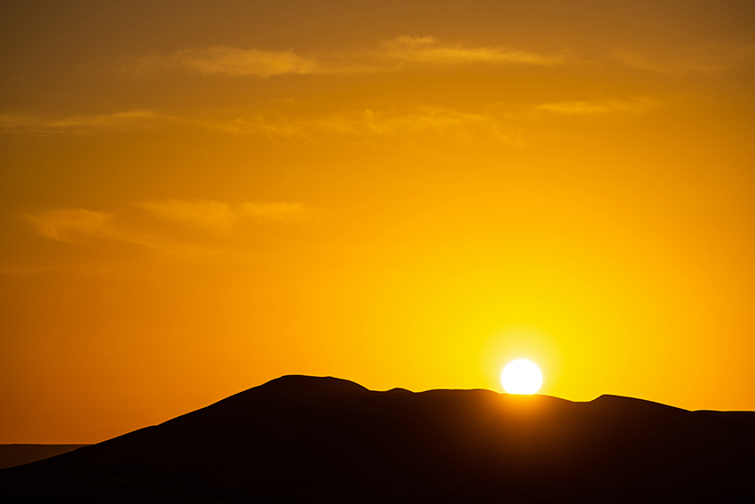 Photo of a Sunset and a Silhouette of a Mountain Shot by Tamron 28-200mm Lens 