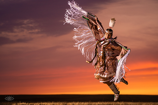 Tribal dancer with feather plume waving arm