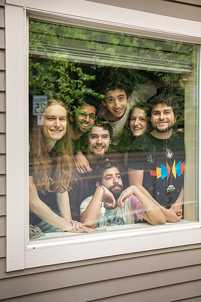 University students smiling through the window