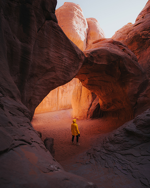 Canyon arches with man in yellow jacket